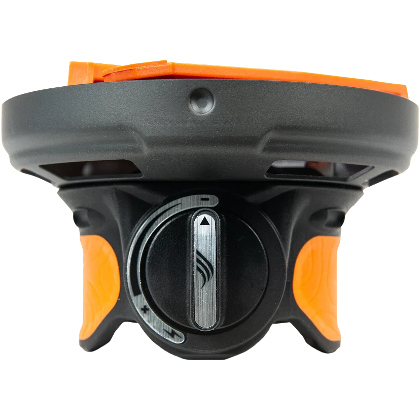 Black and orange device with a central dial on a white background