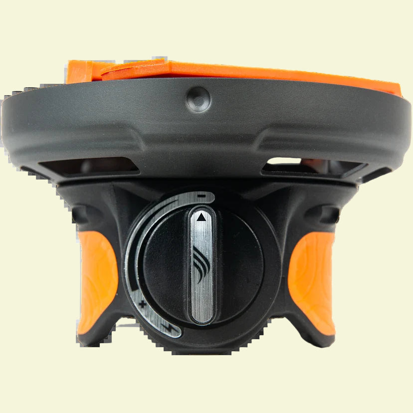 Black and orange device with a central dial on a white background