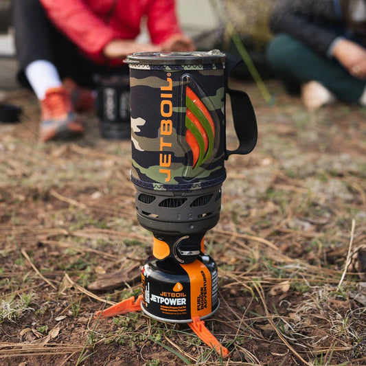 Camouflage Jetboil stove on a grassy outdoor setting