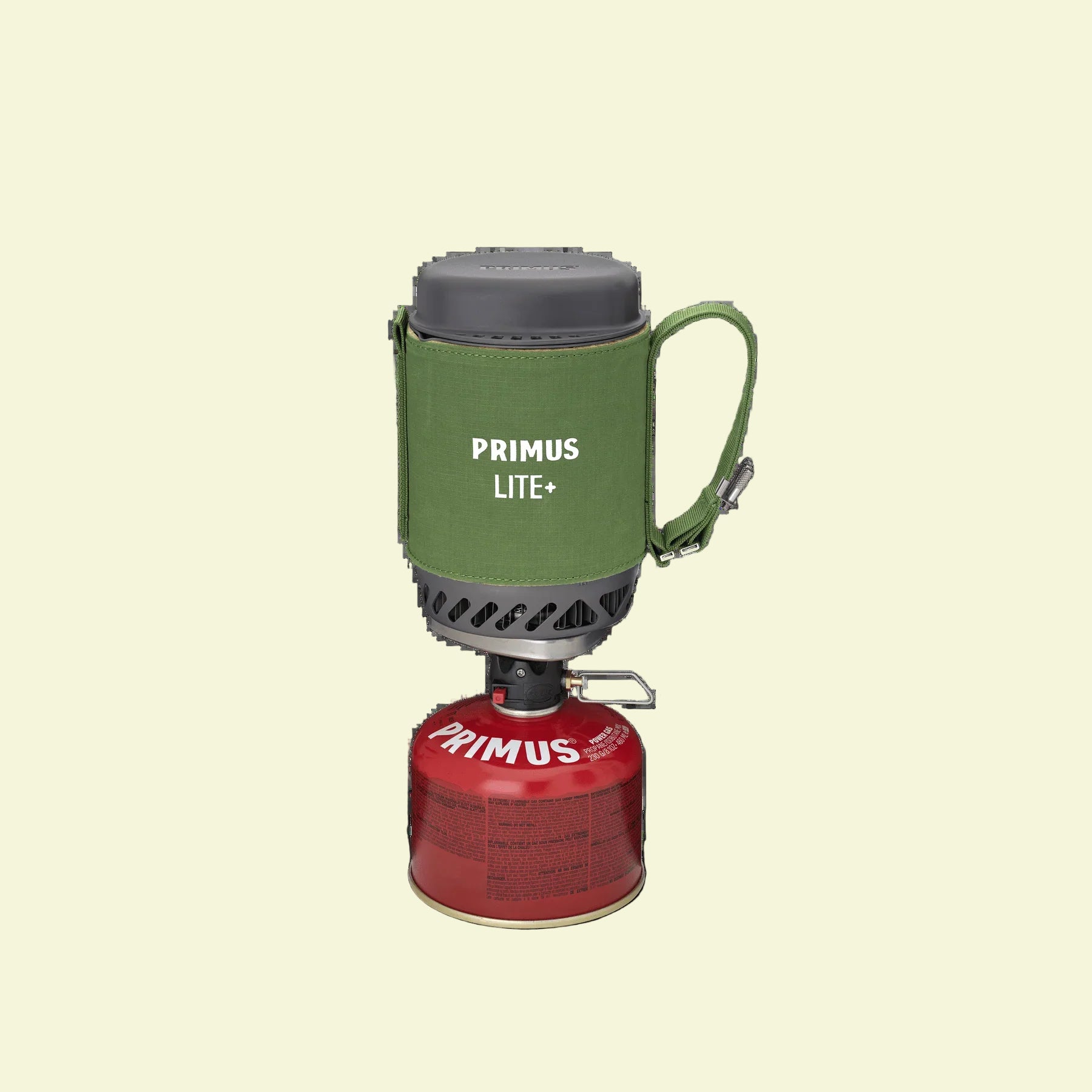 Primus Lite+ camping stove with green container and red fuel canister on a white background