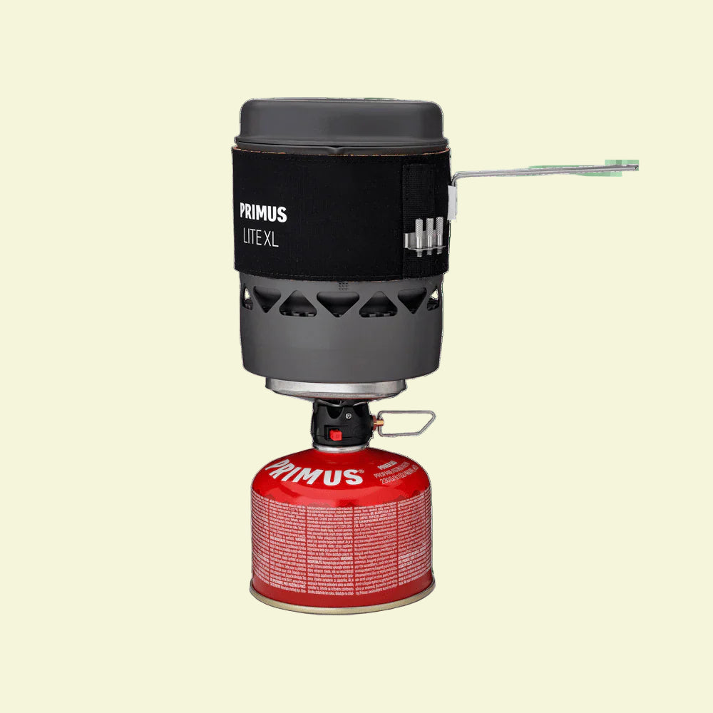 Primus Lite XL camping stove with red fuel canister on a white background