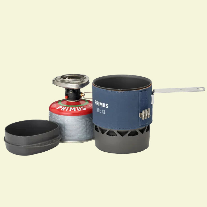Primus camping stove and pot set on a white background