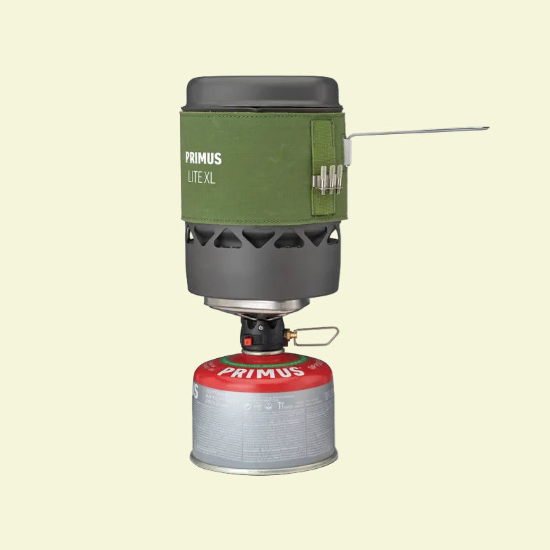 Primus Lite XL camping stove with green carrying case on a white background