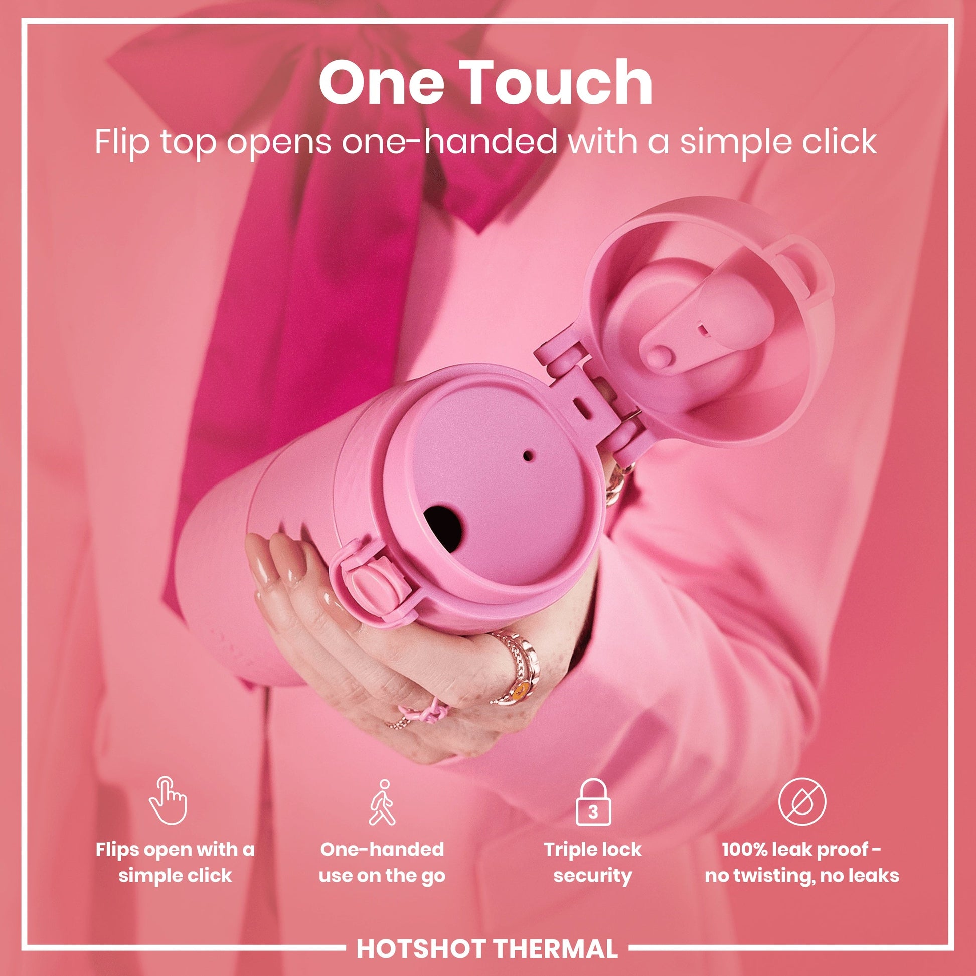 Pink thermal mug with open lid held by a hand, against a pink background.