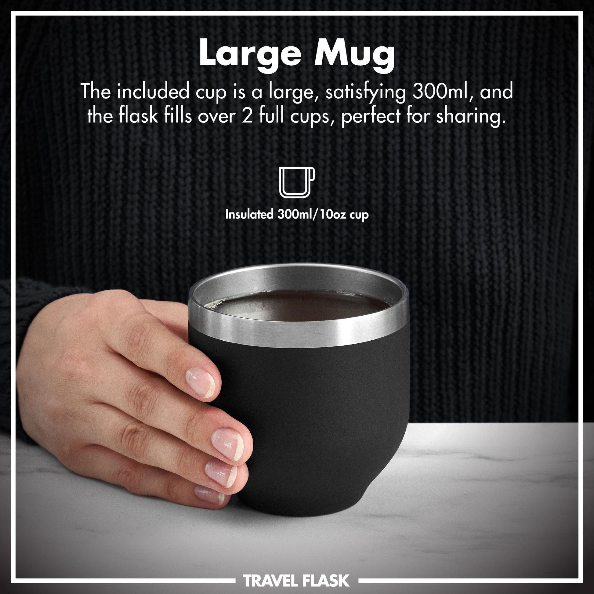 Black insulated travel mug with silver rim held by a hand, against a dark textured background.
