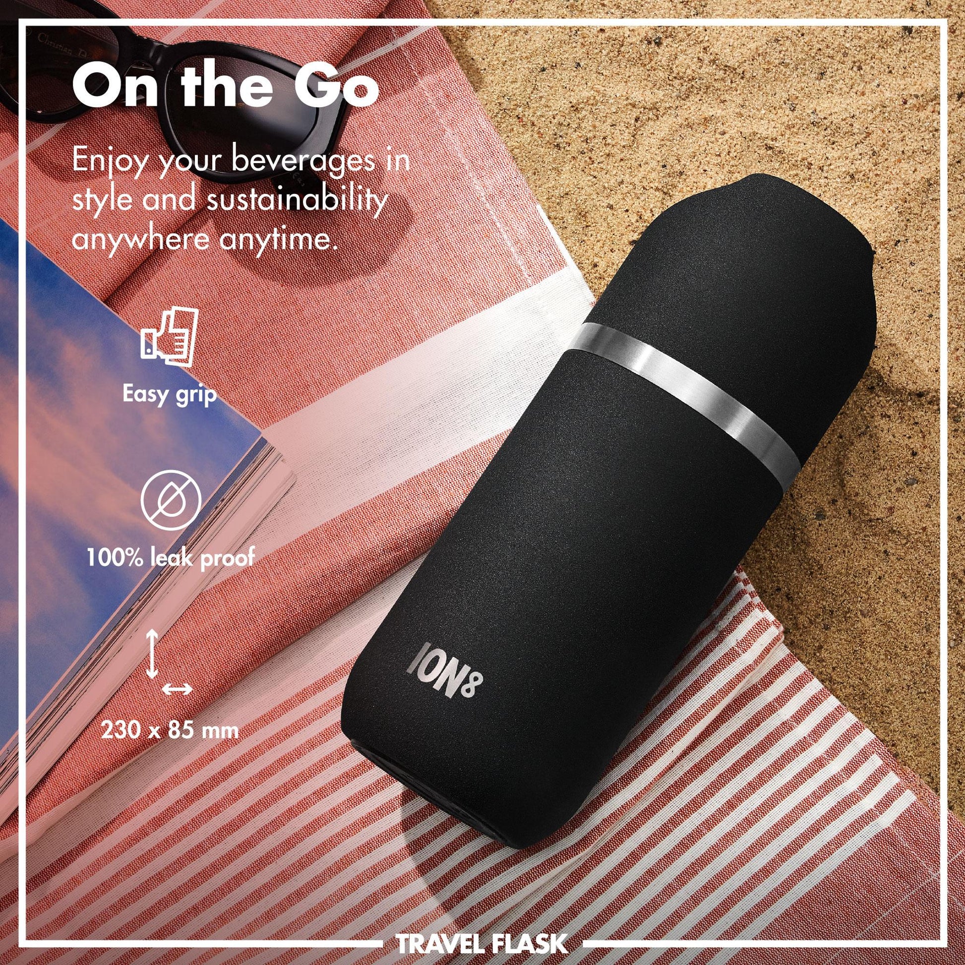 Black travel flask with silver accent on a beach setting, featuring text about its features.