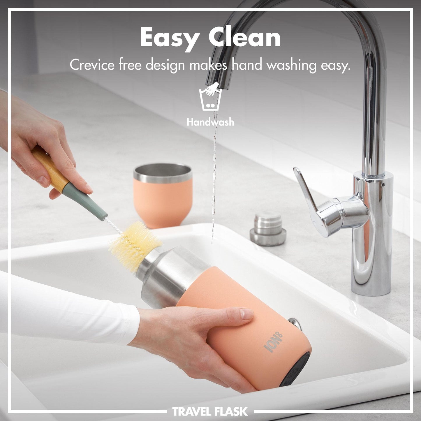 Person cleaning a travel flask with a brush in a sink, emphasizing easy cleaning.