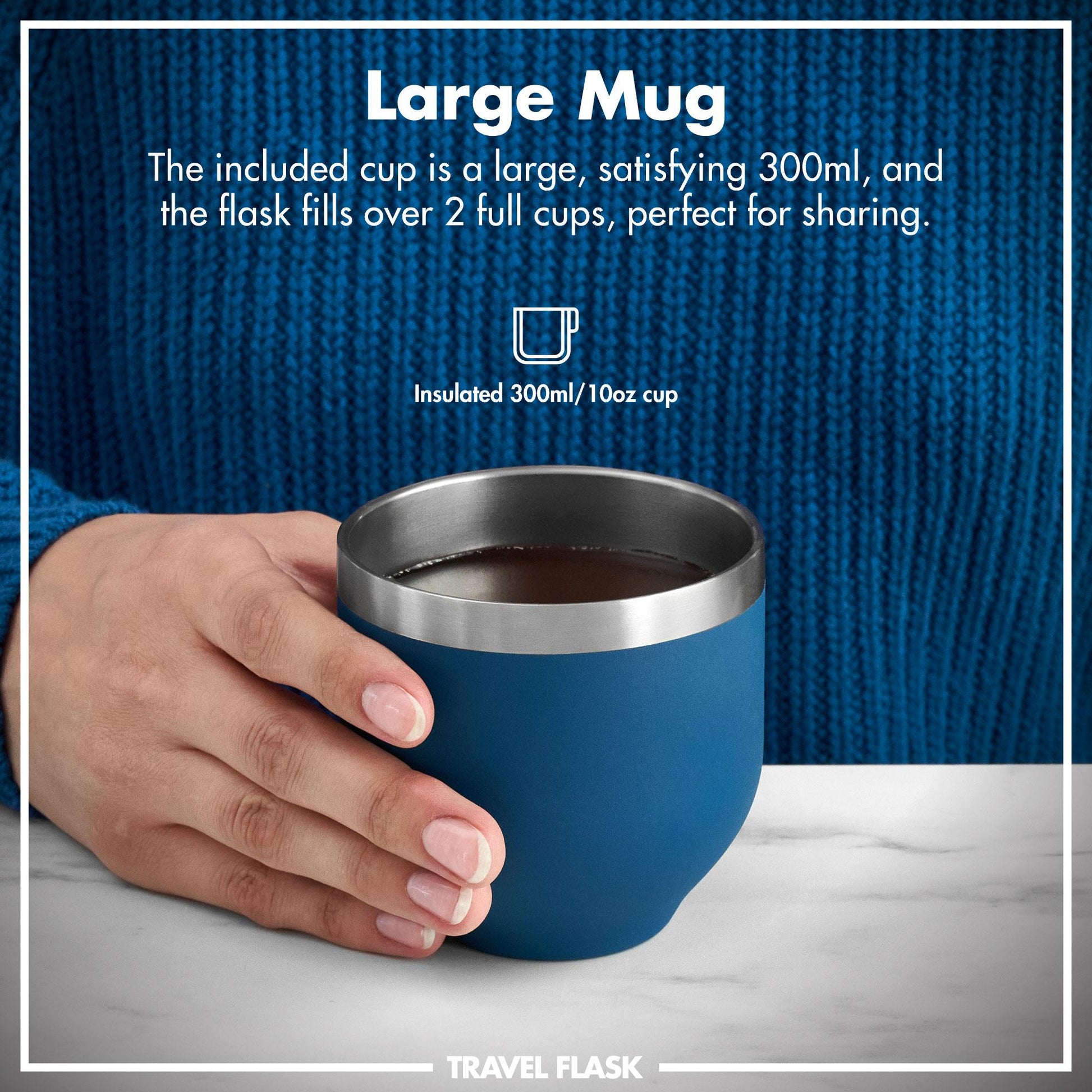 Blue insulated mug with a metal rim held by a hand, against a blue textured background.