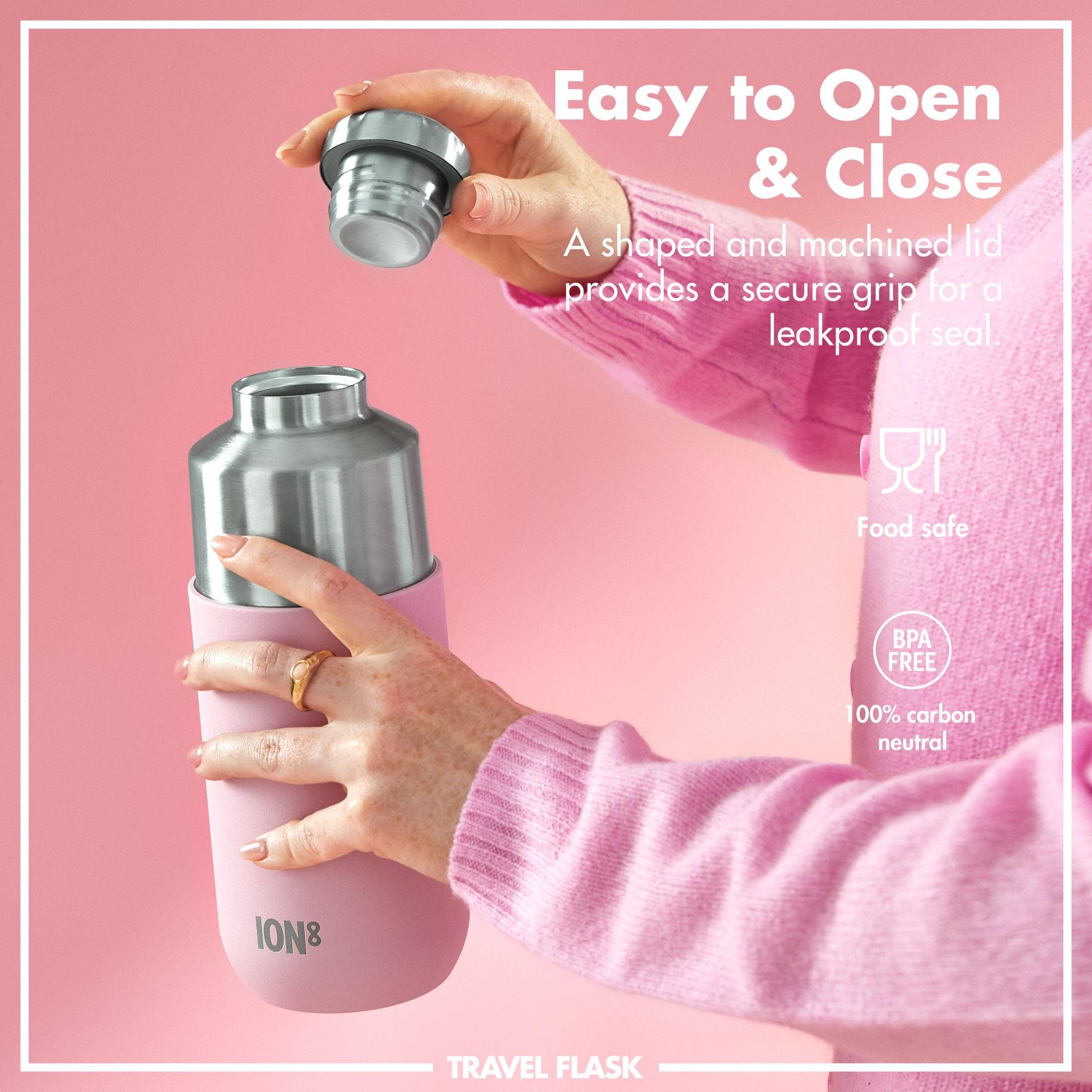 Pink travel flask with silver lid held by a hand against a pink background, featuring text about its features.