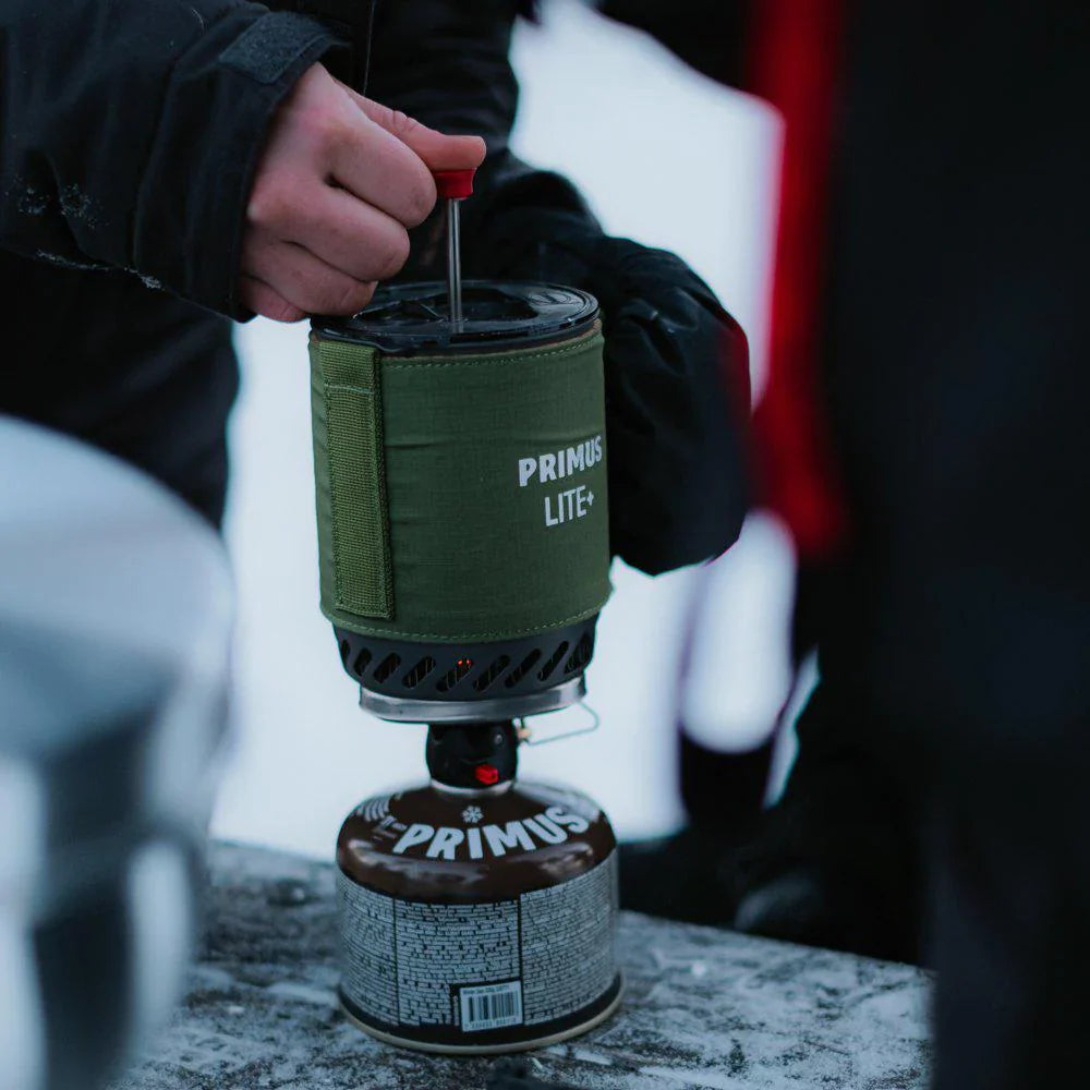 Person using a Primus Lite-X camping stove outdoors