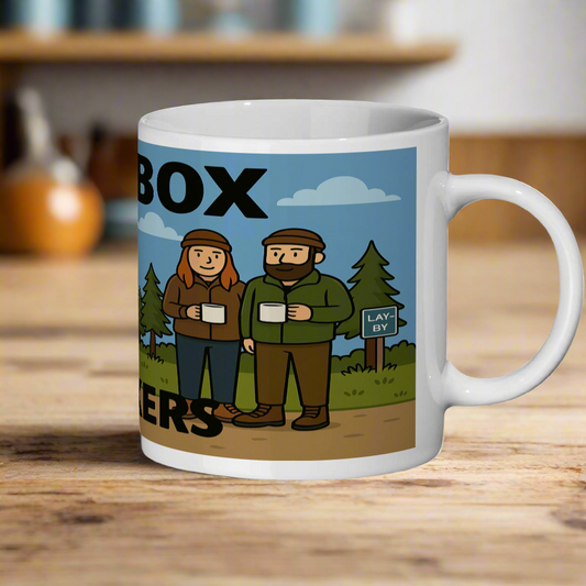 Mug with a graphic design of two people standing next to a sign that reads 'Lay By' on a white background.