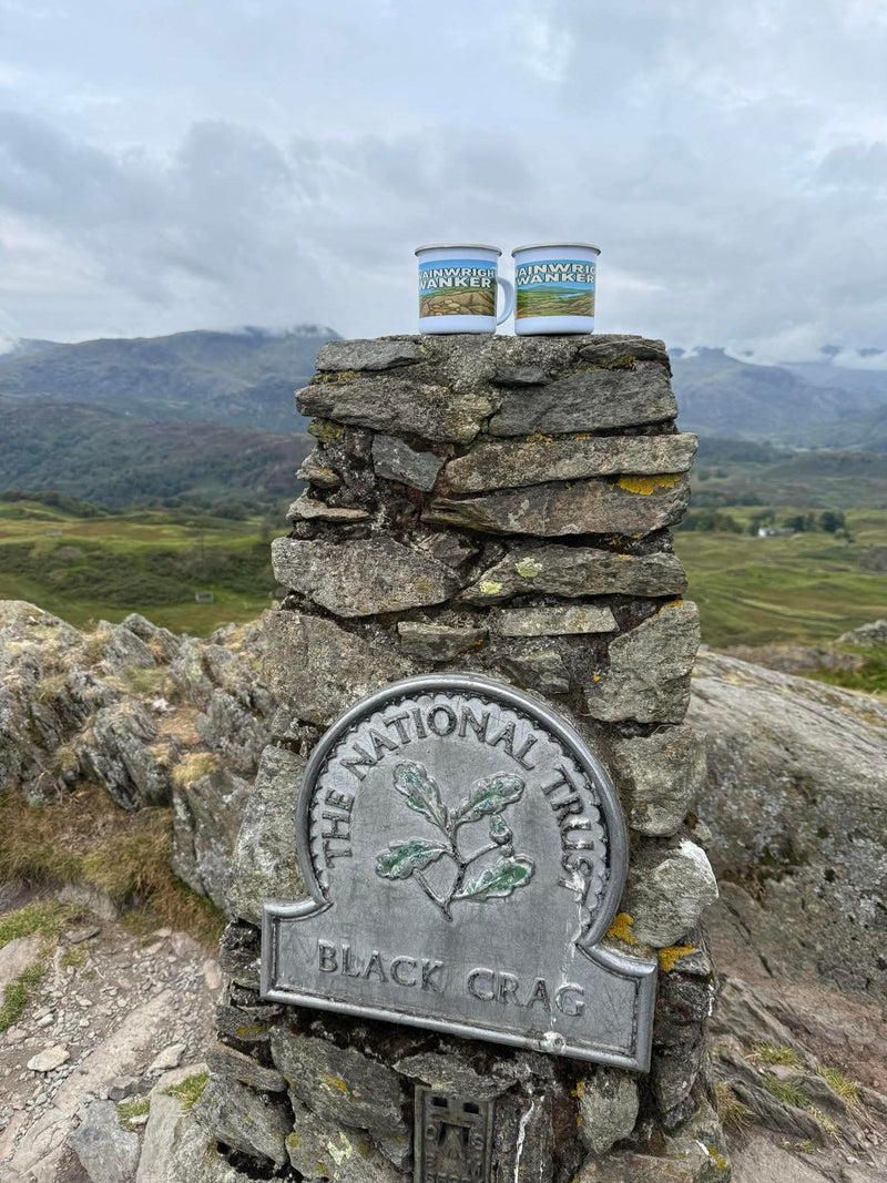 Wainwright Wanker enamel mugs on Black Crag 