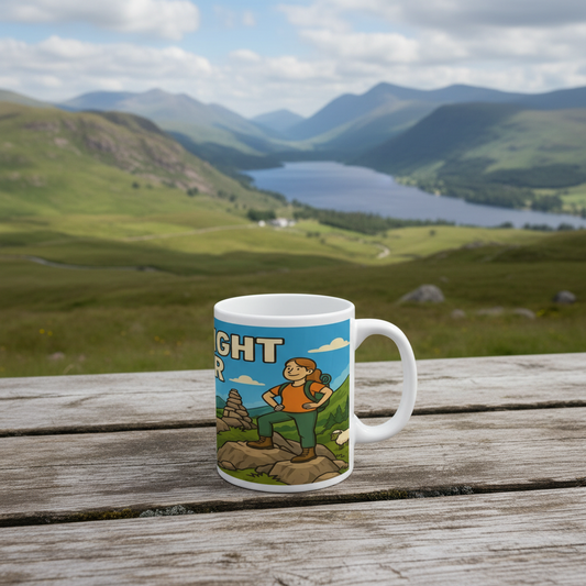 Mug with a scenic design of a person hiking on a wooden table with a mountainous landscape in the background