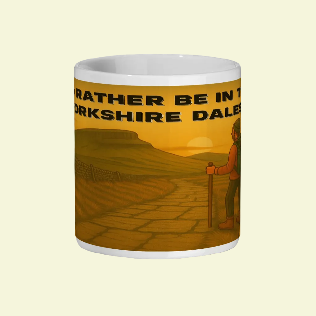 White ceramic mug featuring a hiker and "I'd Rather Be in the Yorkshire Dales" text on a sunset background.