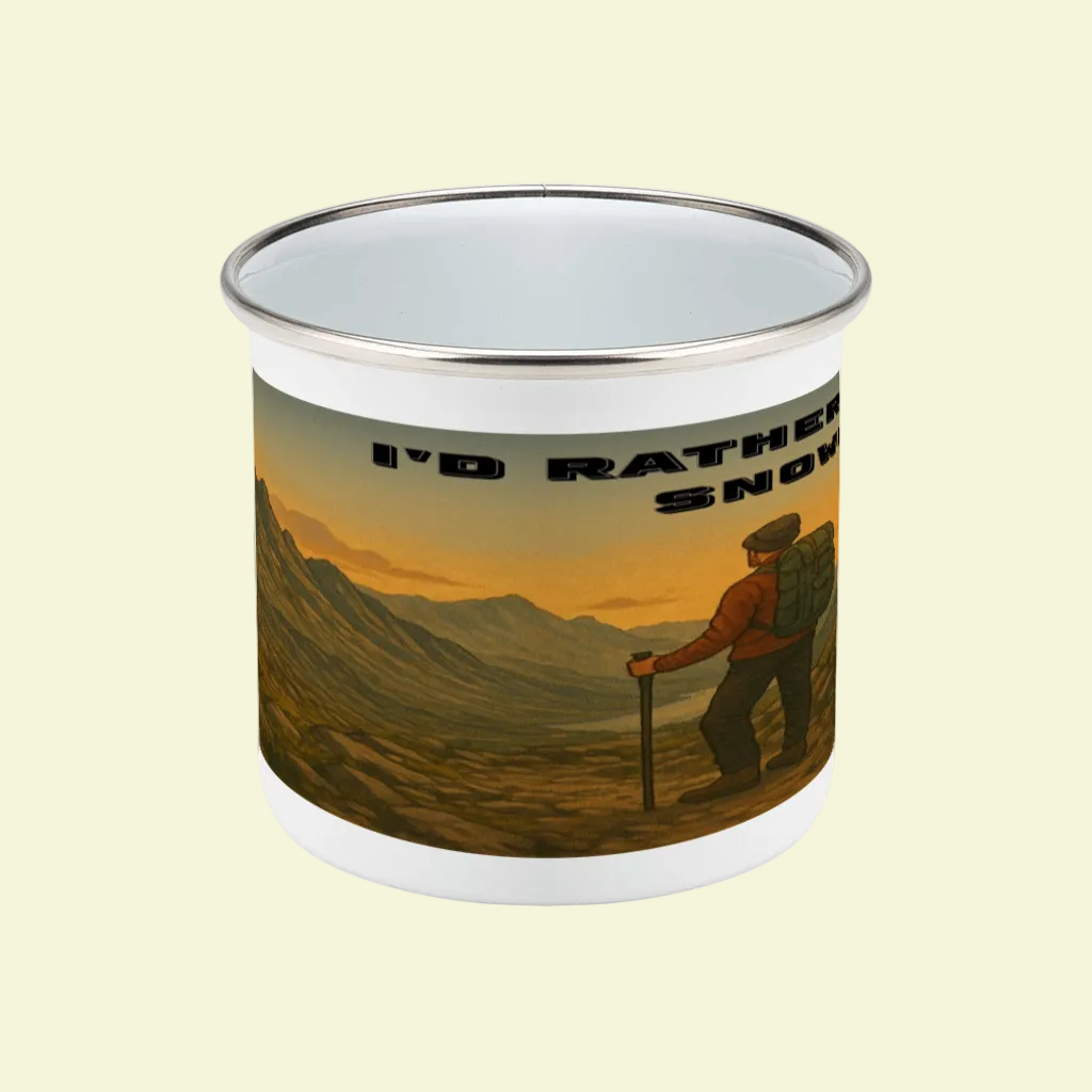 White enamel camping mug with metal rim, featuring hiker and mountain sunset design with "I'd Rather Be in Snowdonia" text.