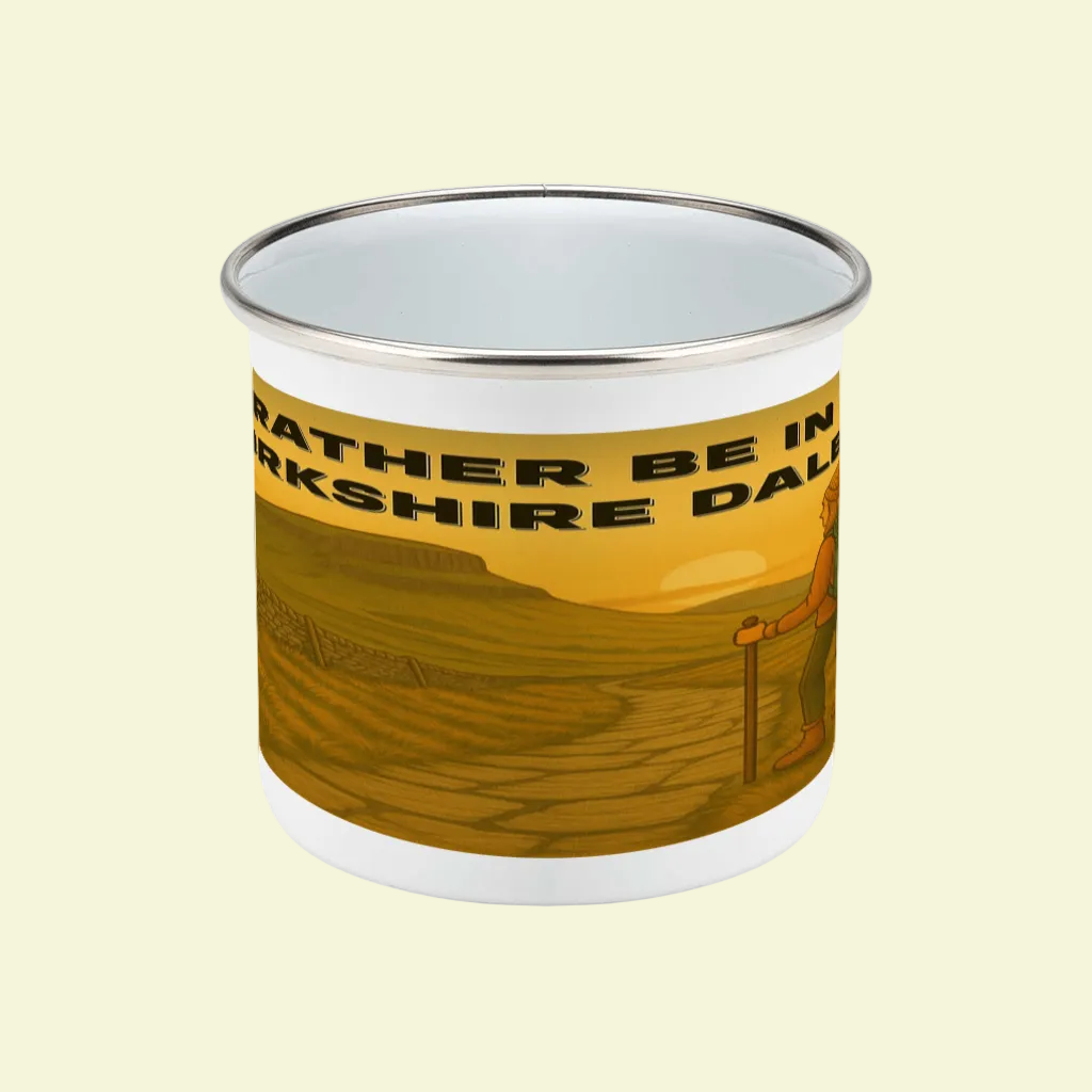 White enamel mug with silver rim, featuring yellow Yorkshire Dales landscape and black text wrap-around design.