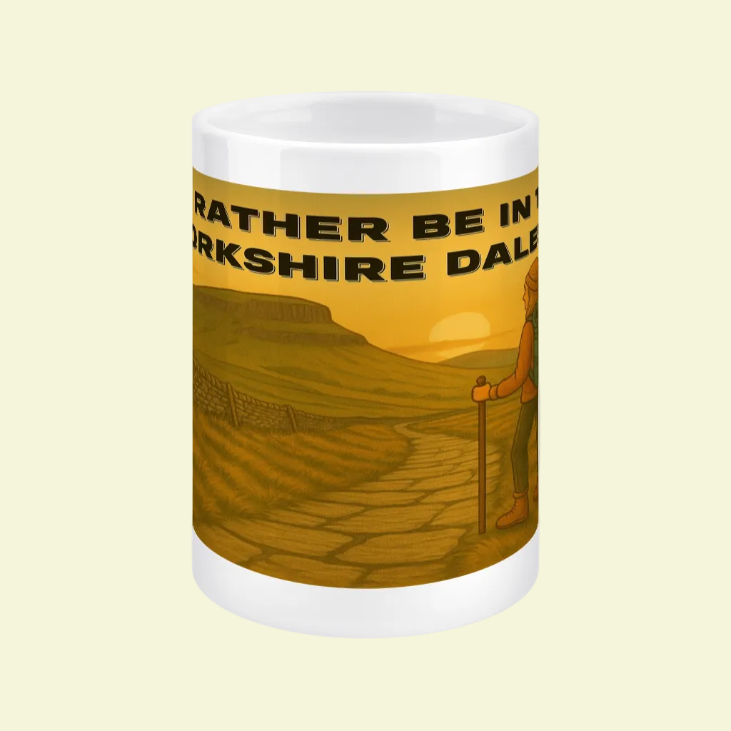 White ceramic mug featuring a hiking woman and Yorkshire Dales sunset with text design.