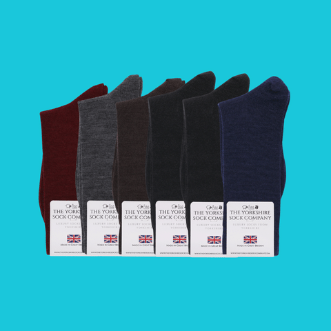 Six pairs of Duchy Everyday Merino Socks in classic dark colors, made in Yorkshire with soft, durable merino wool blend for everyday wear.