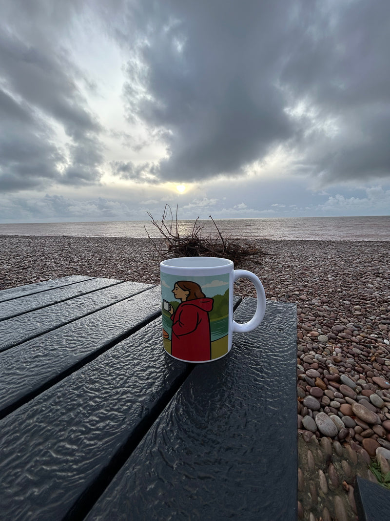 Dryrobe Wanker Ceramic Mug on Budleigh Salterton beach 