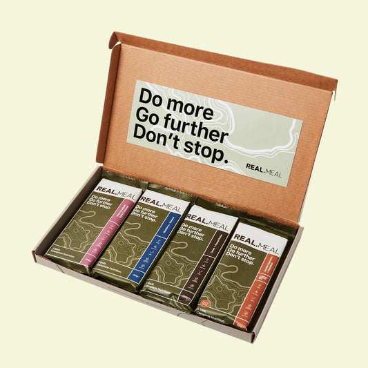 Box of Real Meal bars with motivational quote on a white background