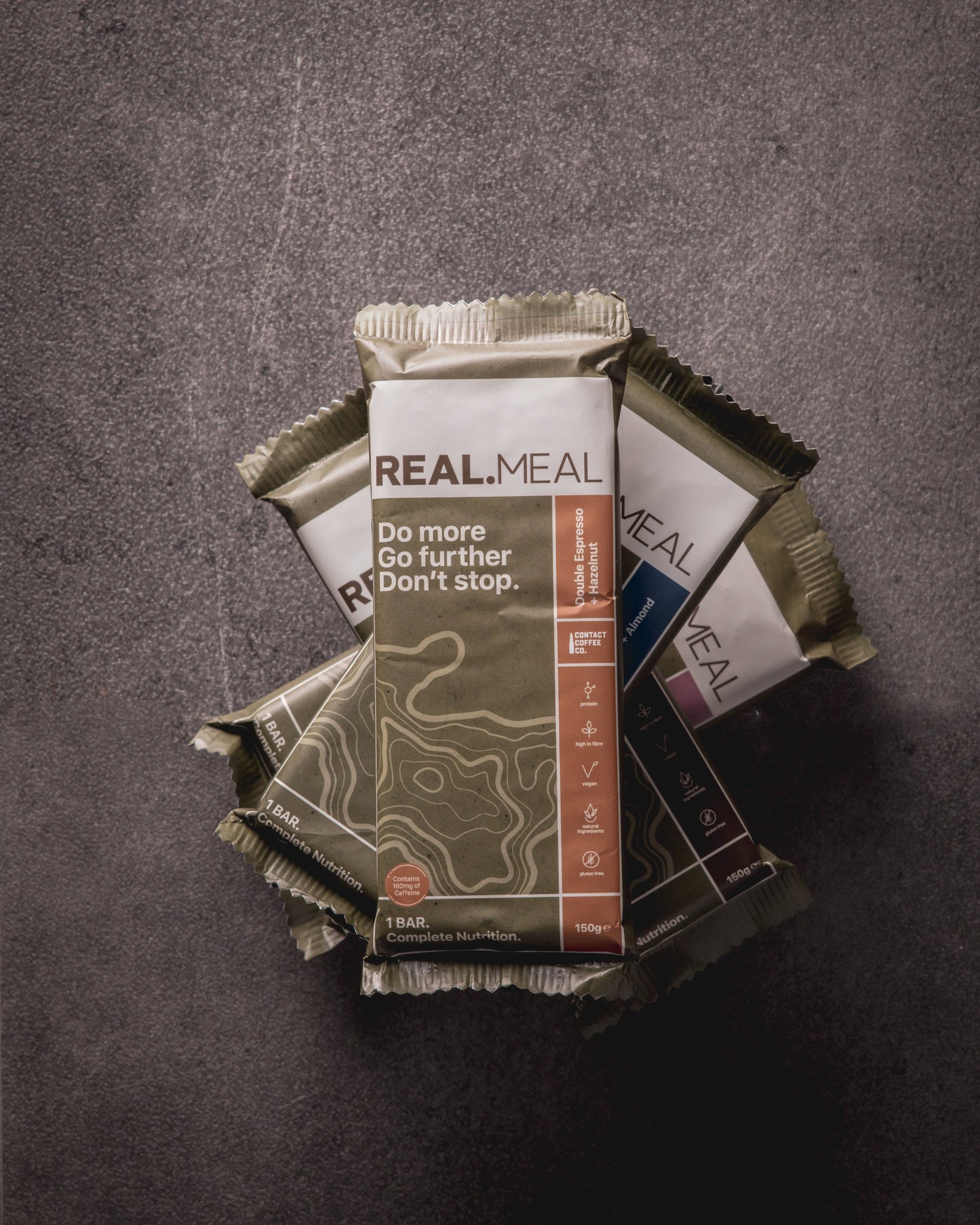 Real Meal meal kit packages on a textured gray background