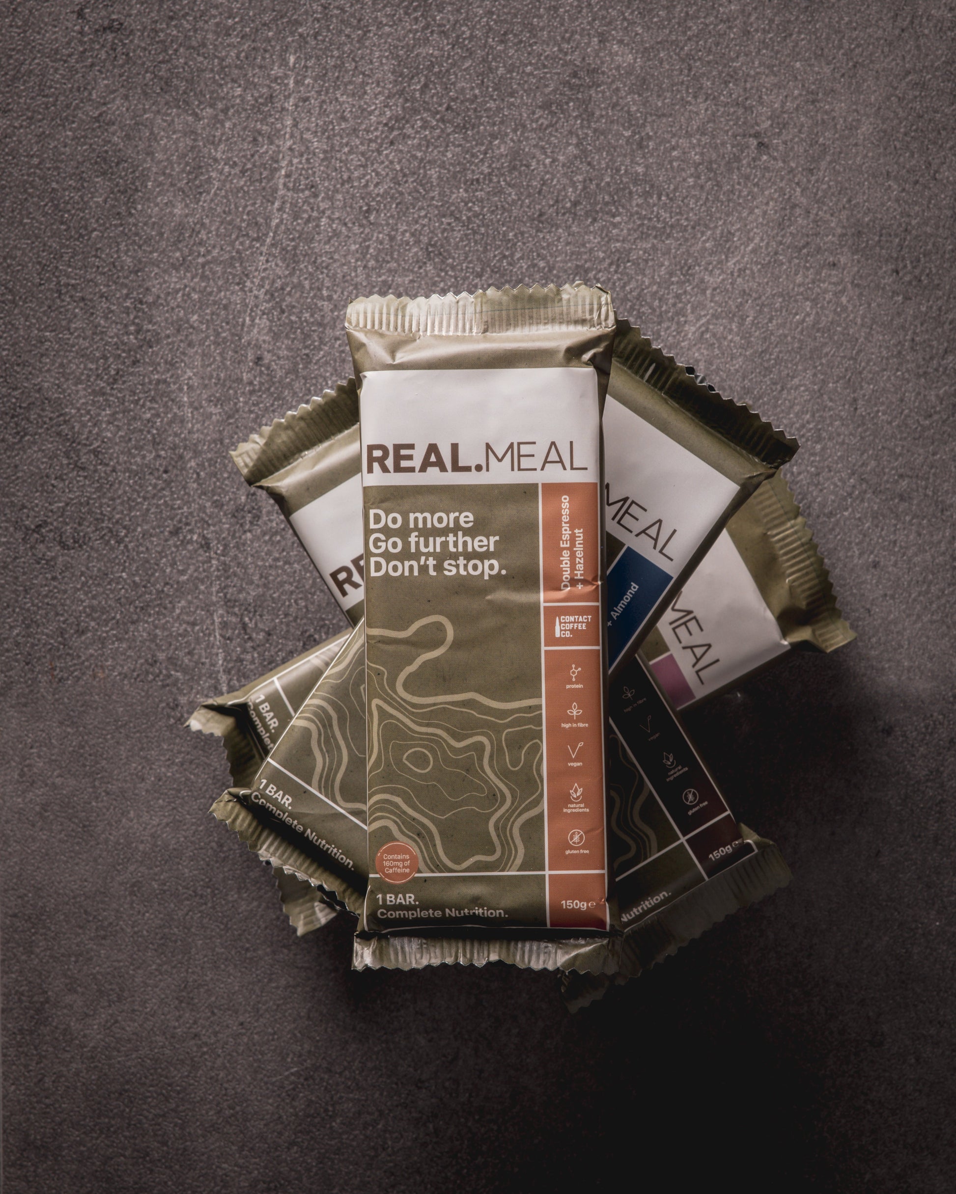 Real Meal meal kit packages on a textured gray background