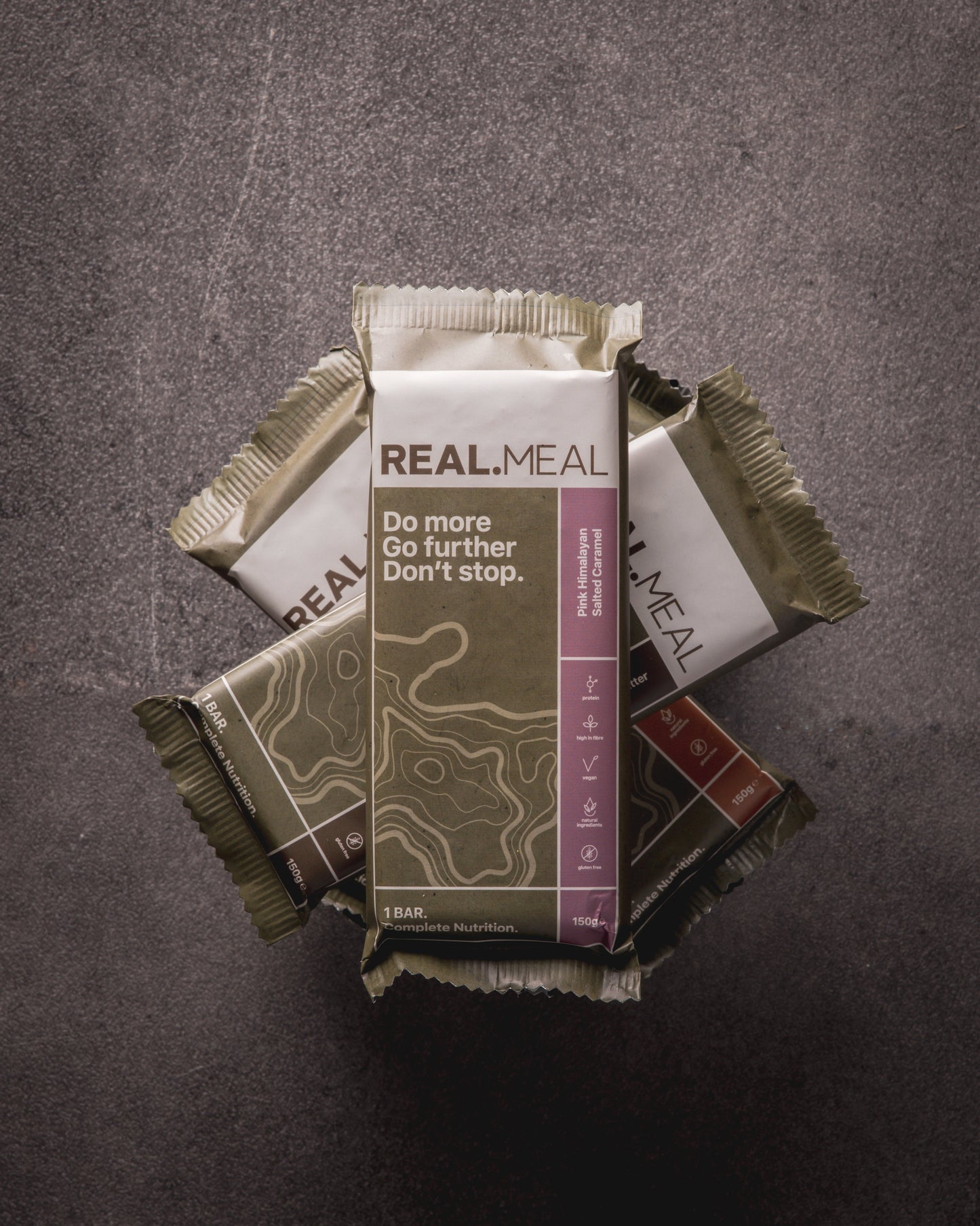 Real Meal bars stacked on a dark background