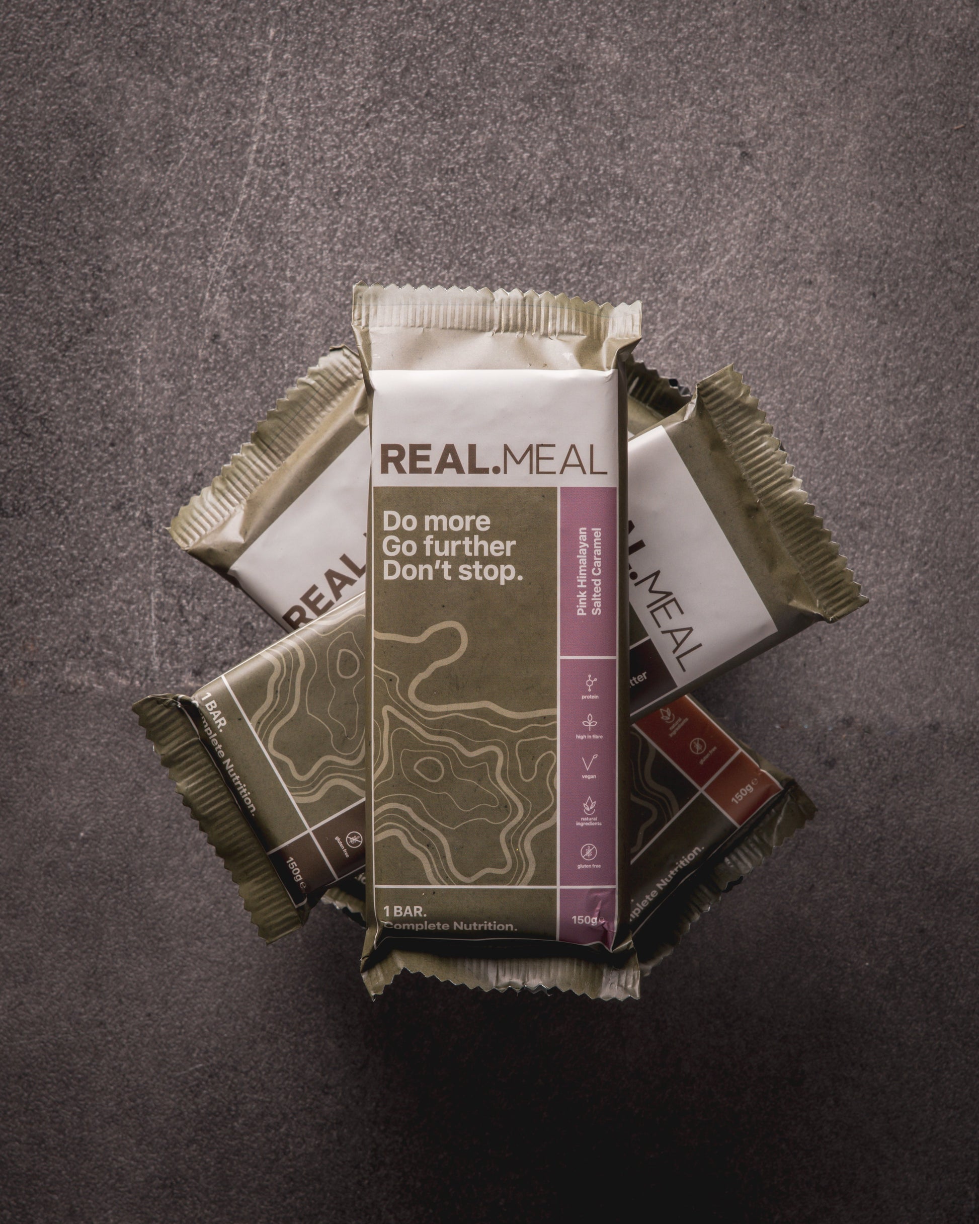 Real Meal bars stacked on a dark background