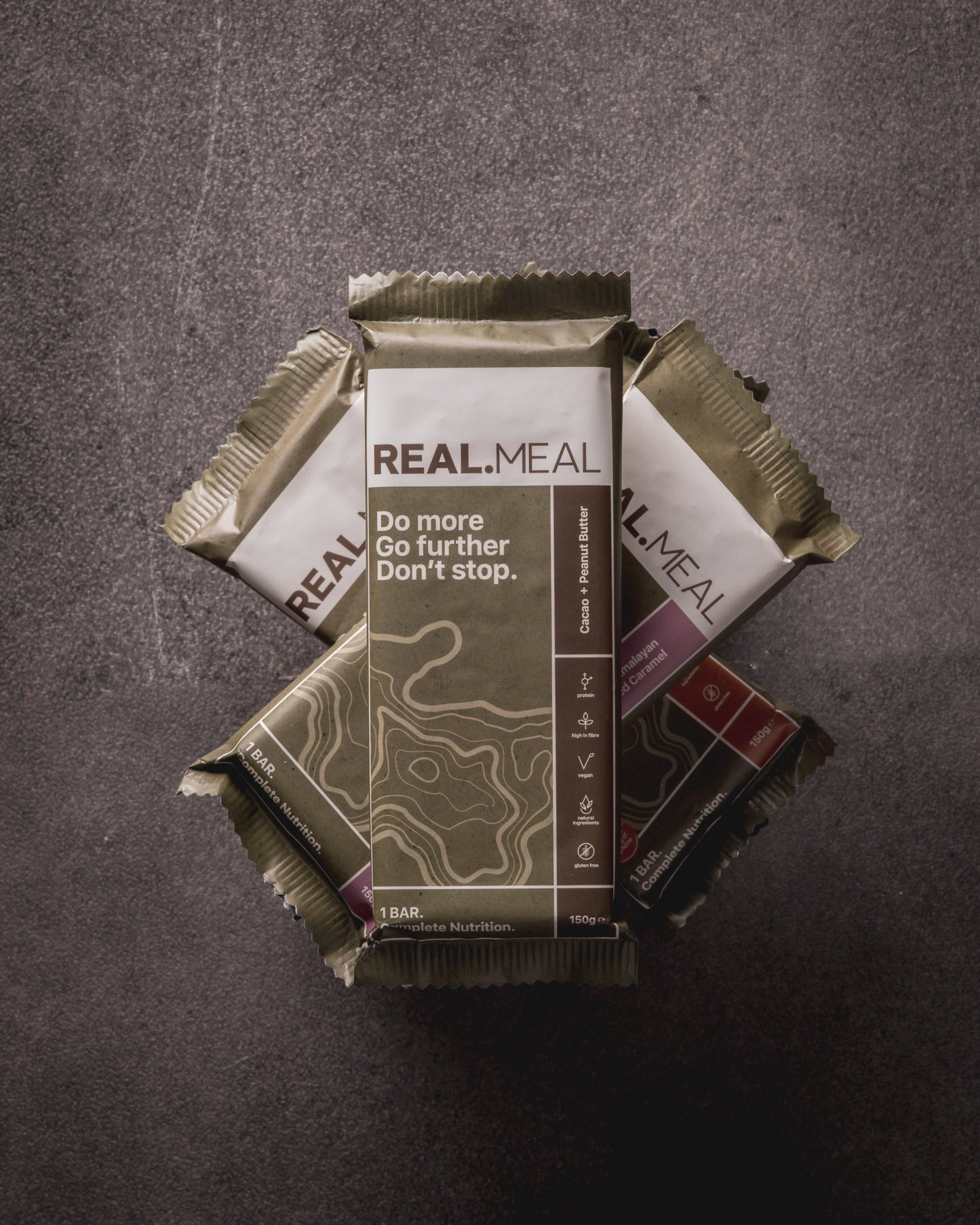 Real Meal bars stacked on a dark surface