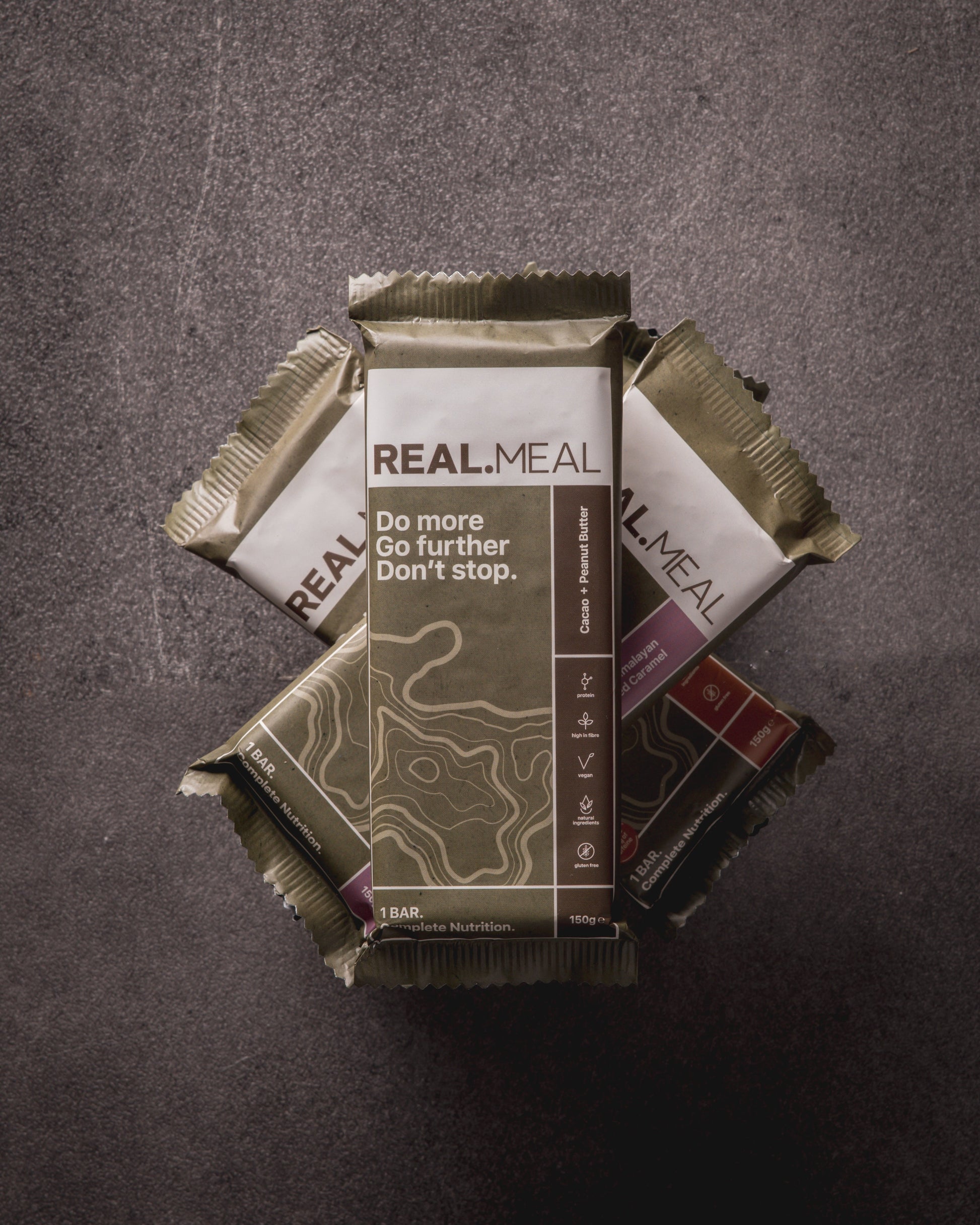 Real Meal bars stacked on a dark surface