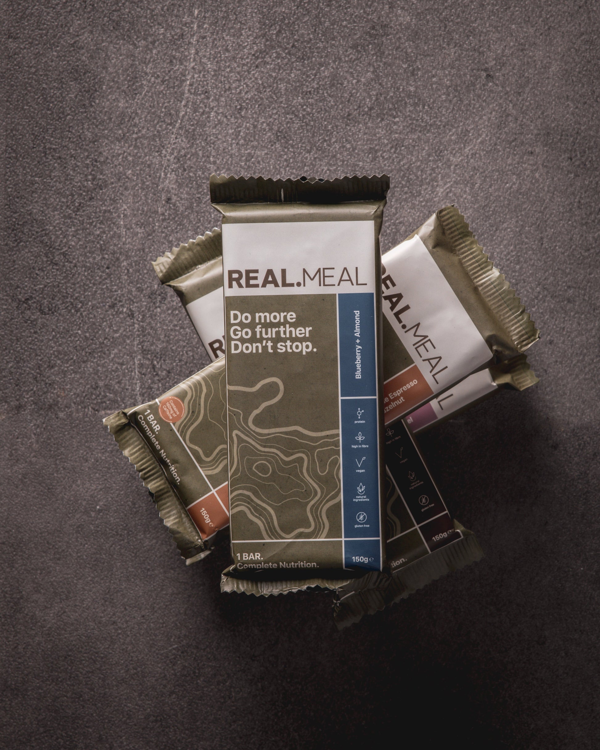 Real Meal bars stacked on a dark surface