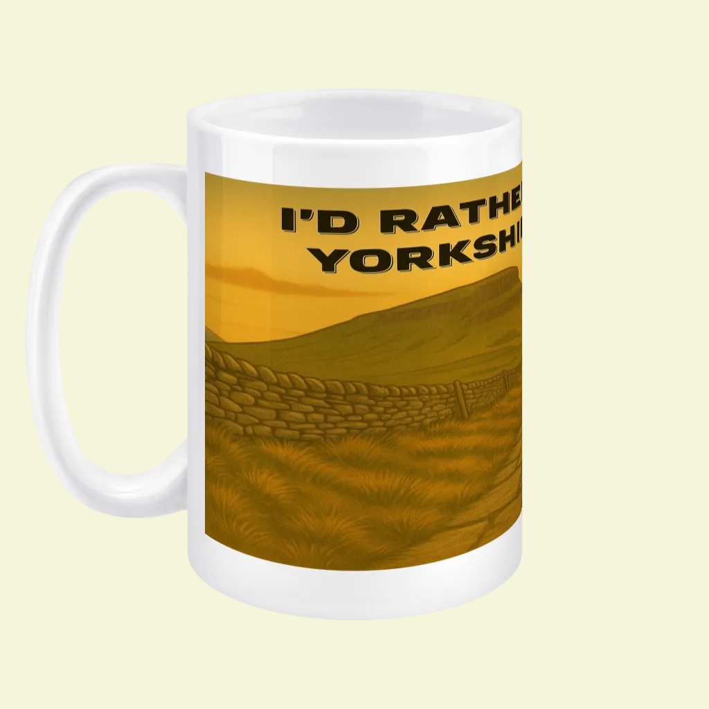 White ceramic mug with yellow landscape and black text "I'd Rather Be in the Yorkshire Dales".