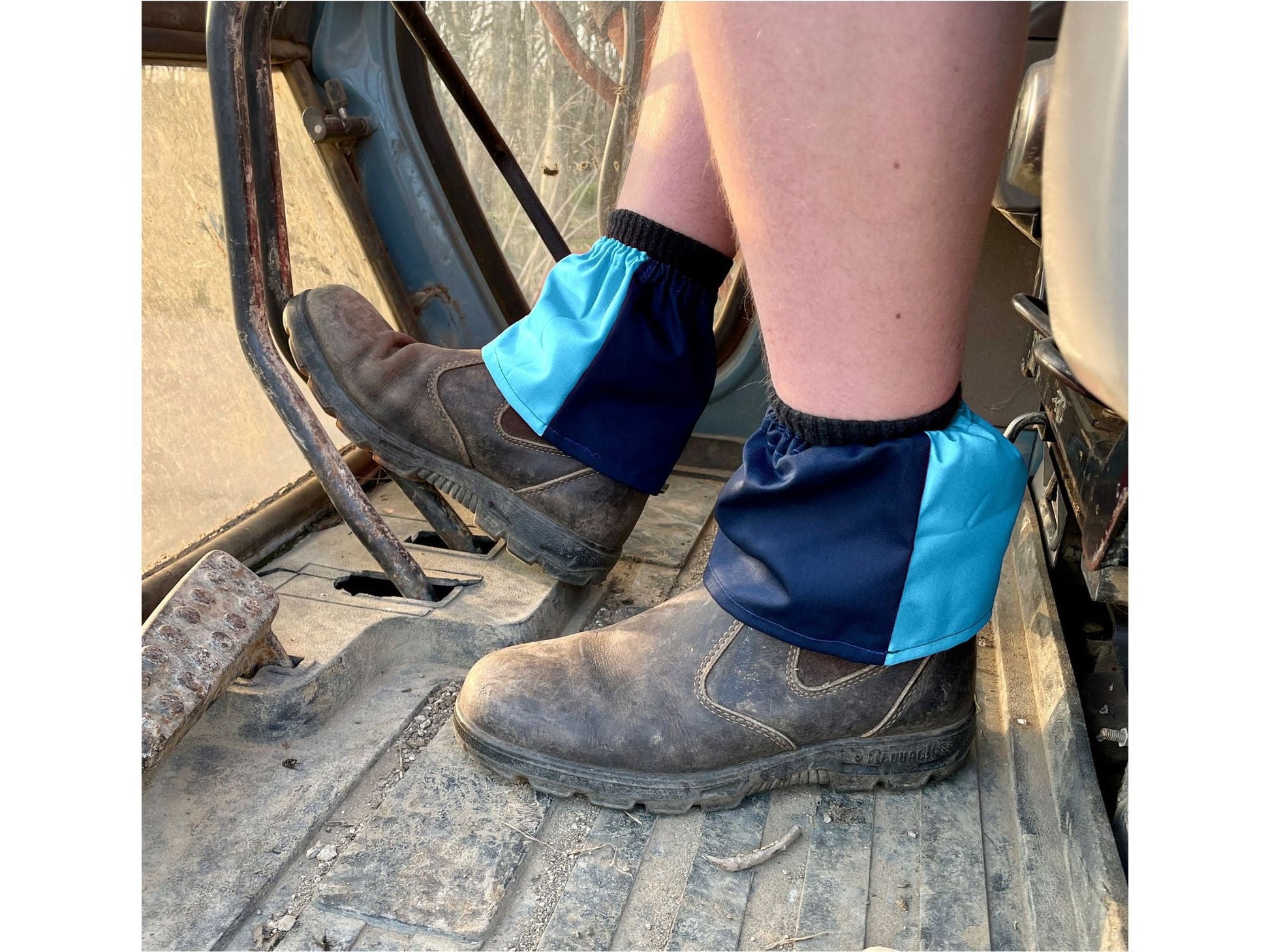 Person wearing blue boot covers on a construction site