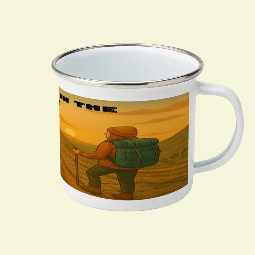 White enamel mug with silver rim featuring a hiker with a large green backpack against a sunset mountainous landscape.