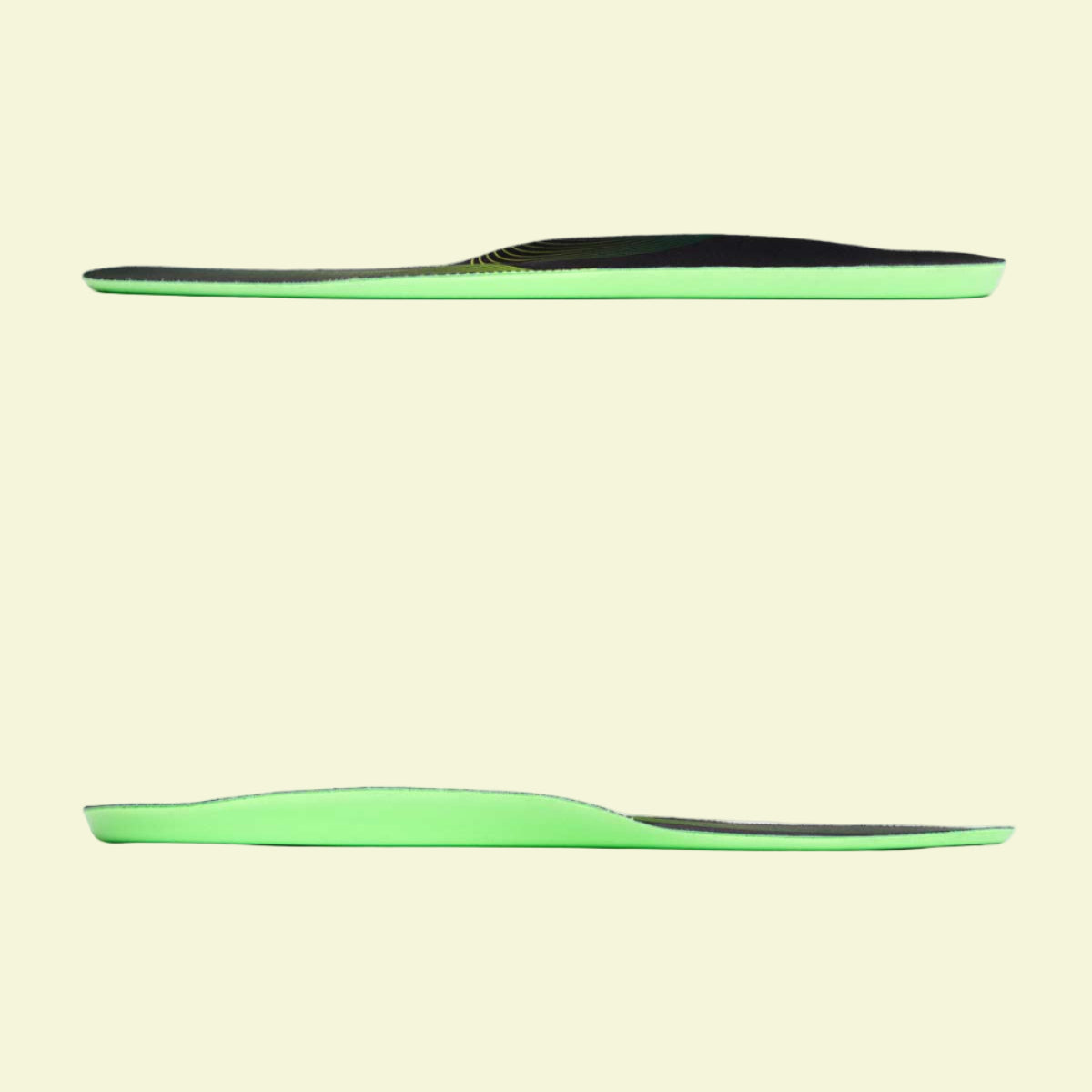 Two green and black insoles on a white background