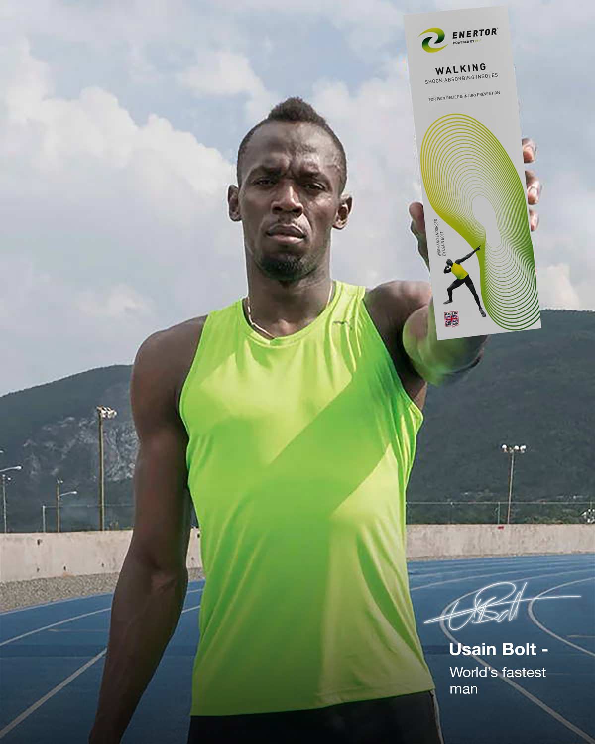 Athlete holding a shoe and packaging on a track with mountains in the background