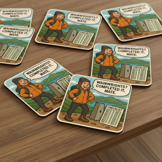 Set of themed coasters with illustrations and text on a wooden surface