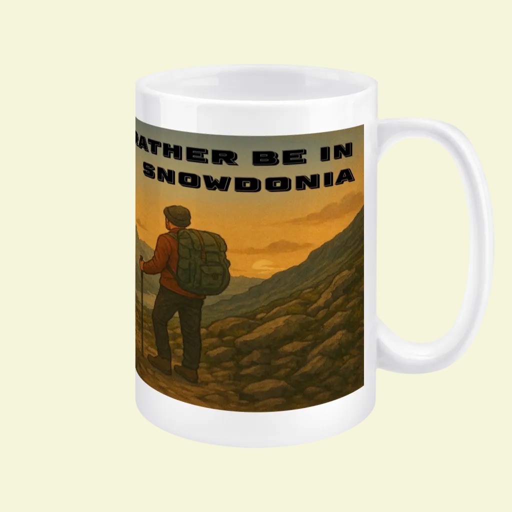 White ceramic mug with a hiker and "Rather Be In Snowdonia" text over a mountain landscape background.