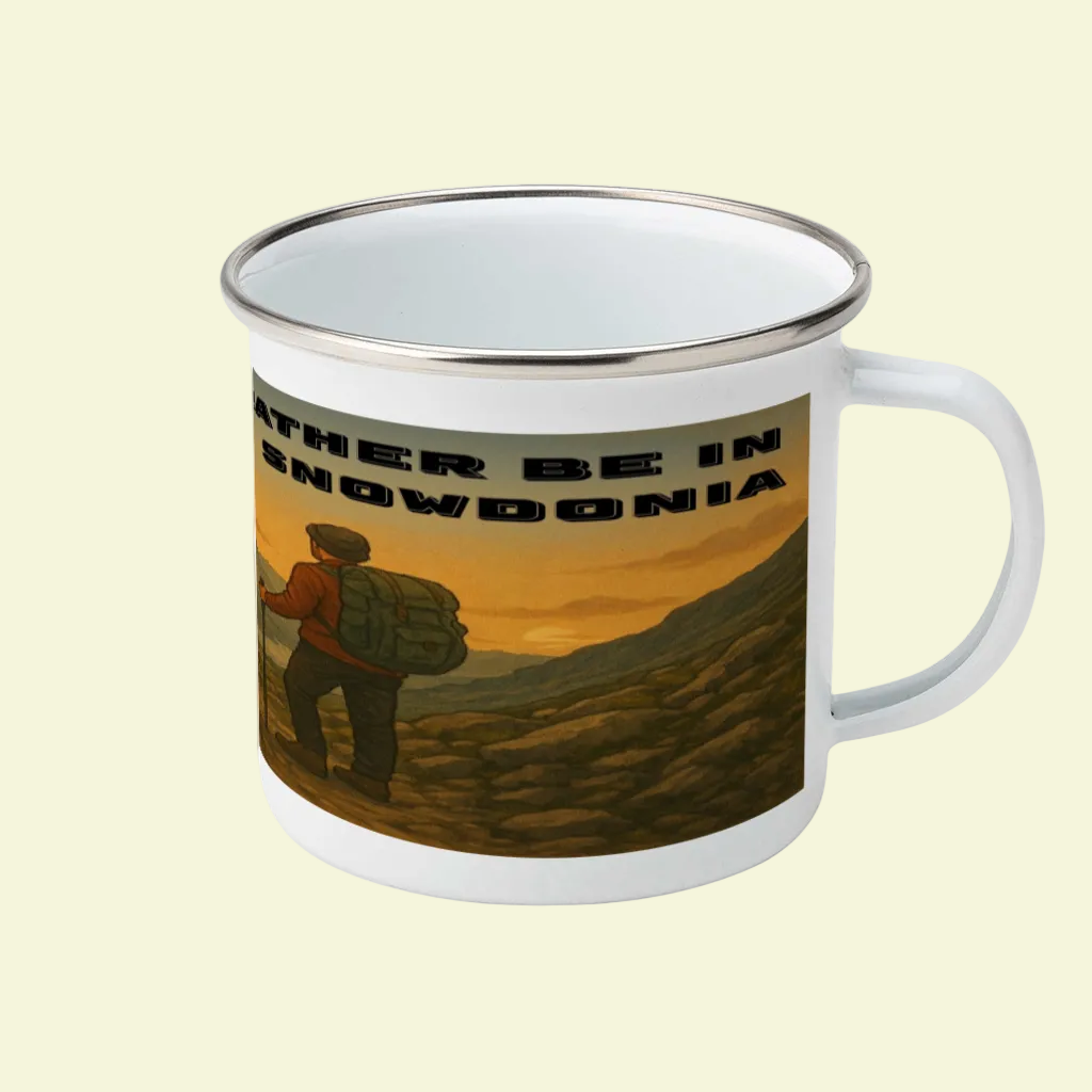 White enamel camping mug with metal rim, featuring a hiker and "I'd Rather Be in Snowdonia" text in bold black letters.
